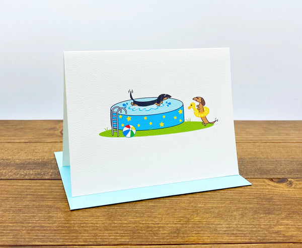 Dachshund pool party cards.  One dachshund splashing in the pool and the other wearing a bright yellow swim floatie.