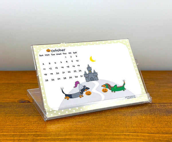 Calendar with cartoon dogs and a castle on a wooden surface