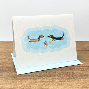 Note card featuring two dachshunds under the sea wearing snorkeling gear.