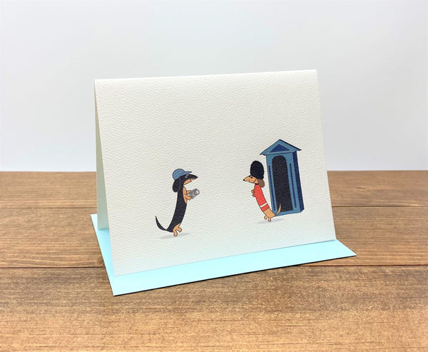 Two dachshunds in London cards.  Tourist dachshund and Queen's Guard dachshund. 